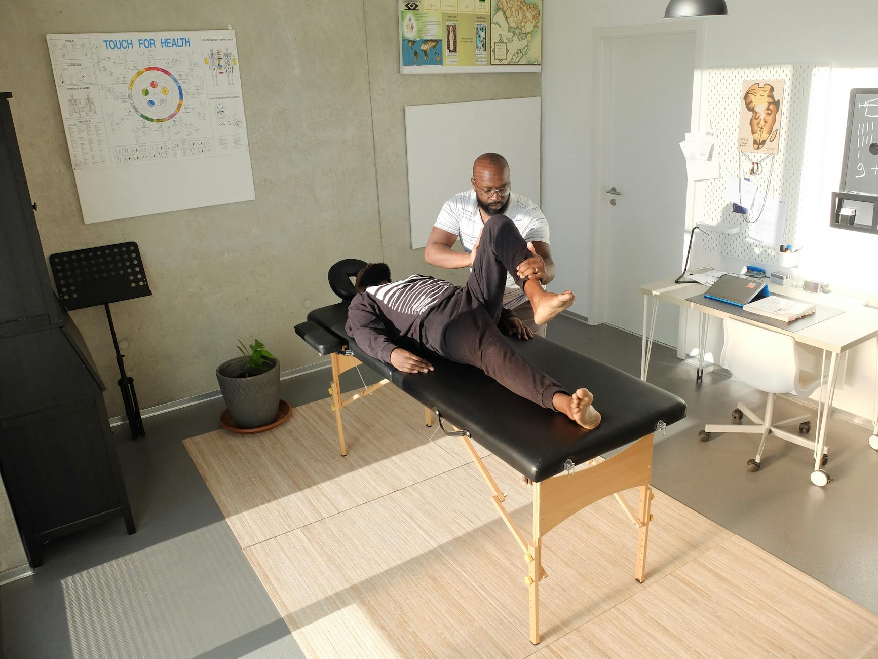 Warm inviting chiropractic clinic interior with treatment tables and natural light