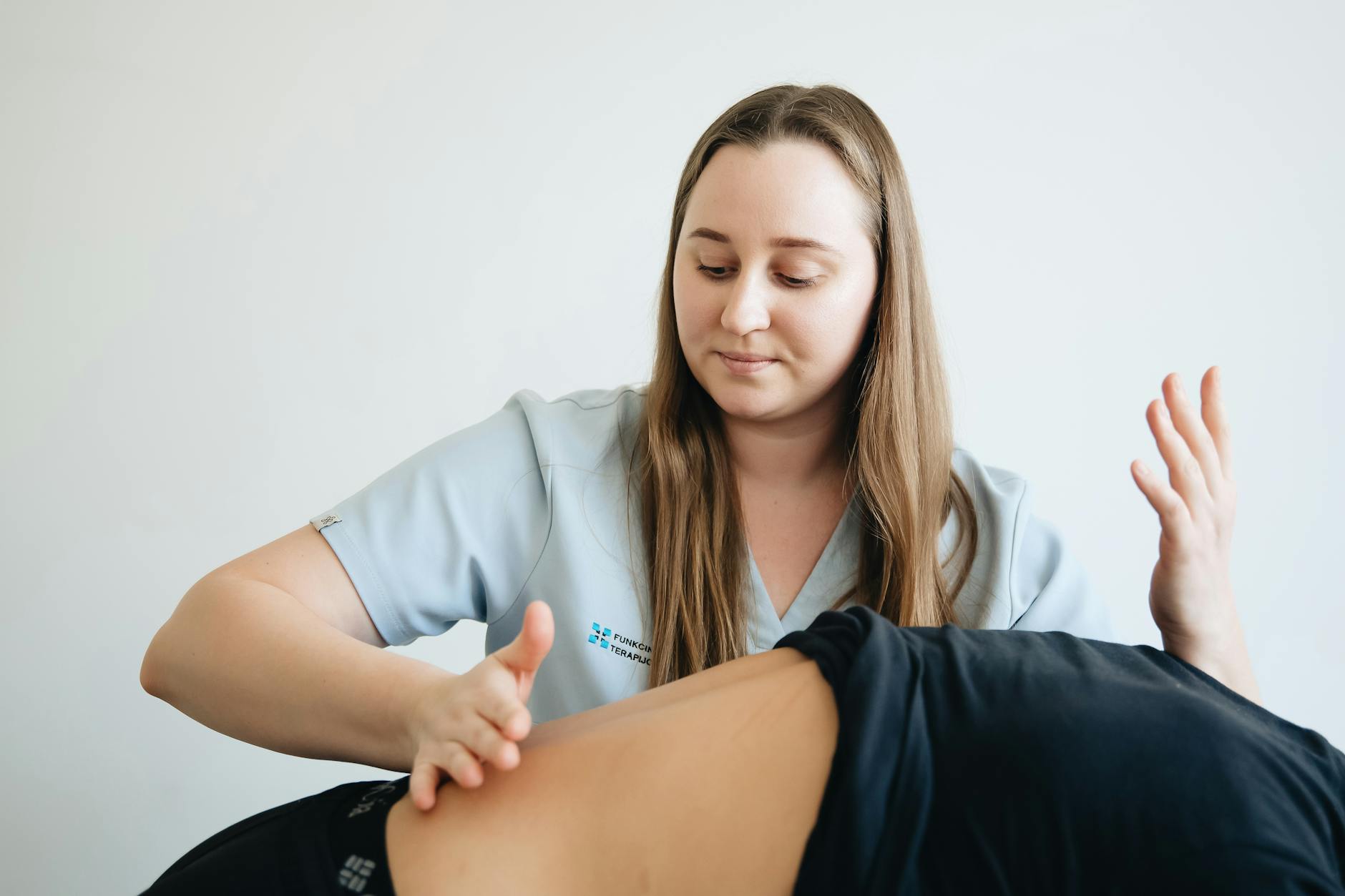 Therapist performing deep tissue massage on patient lower back